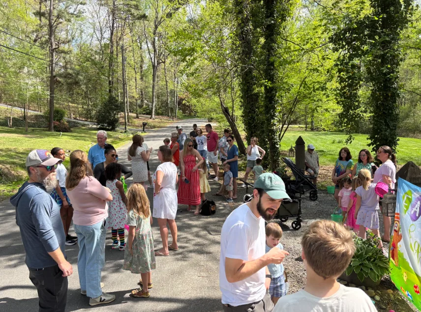 Neighbors and families gathered along a wooded path.